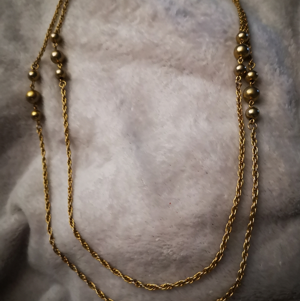 Very long gold tone necklace